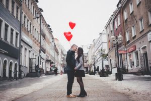 Couple met on Dating App kissing between urban street