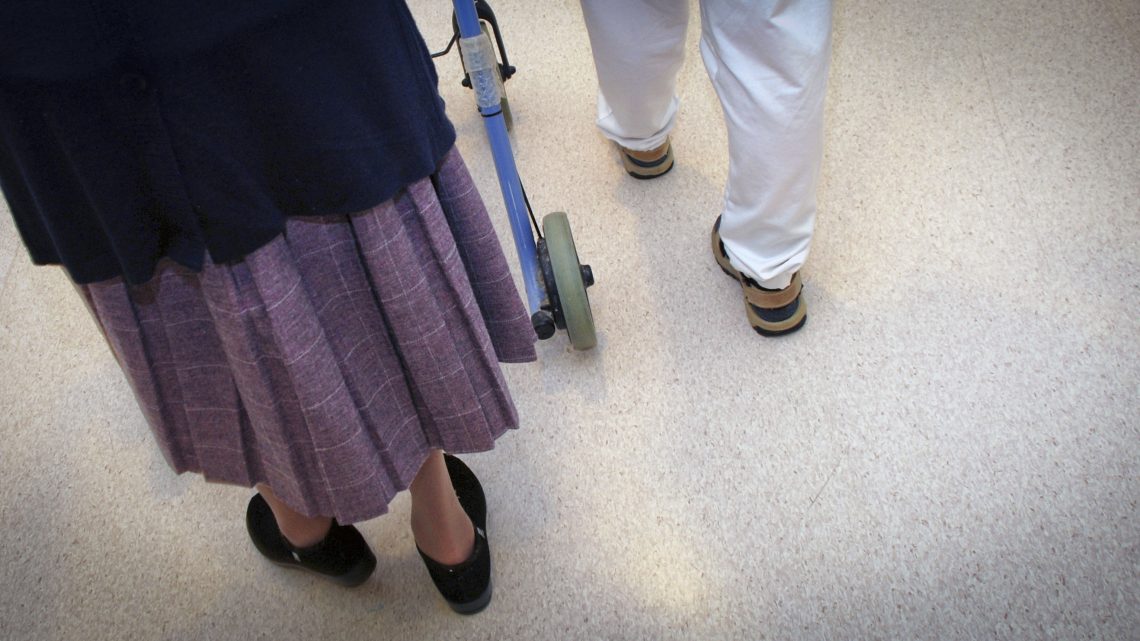 Elderly woman walking in nursing home