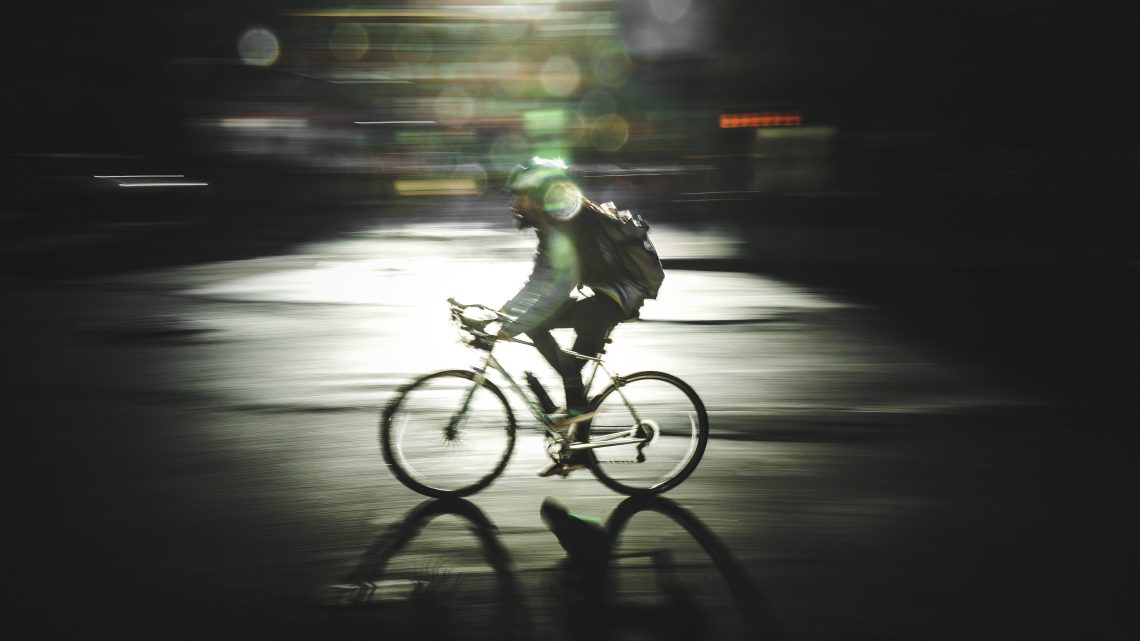 Man riding bike at night