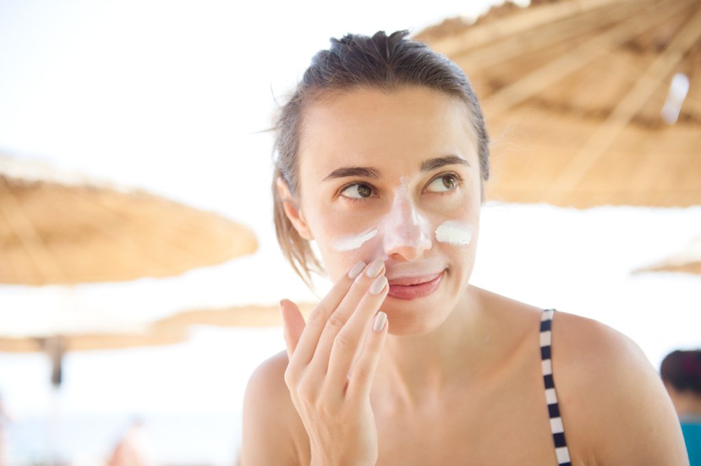 Woman applying sunscreen for protection from sun