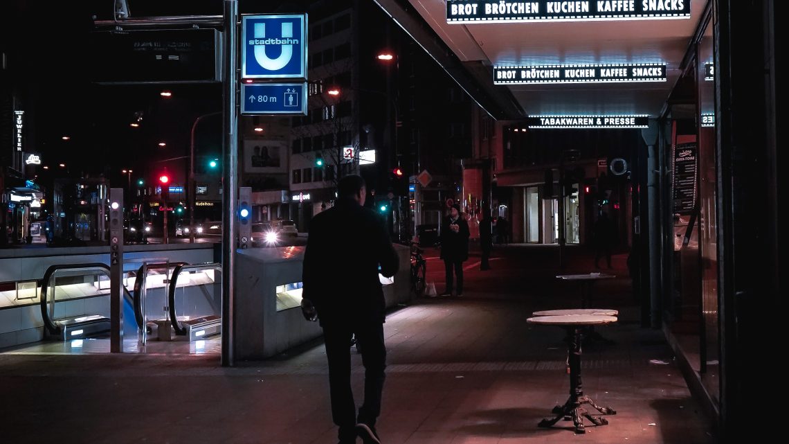 person walking in the city at night