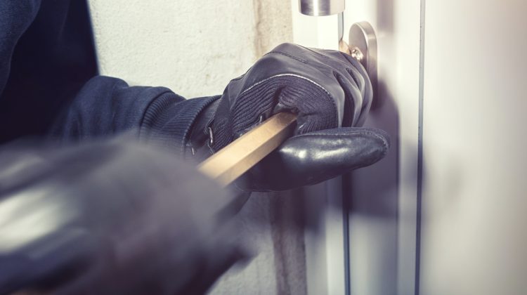 burglar trying to break in to a house