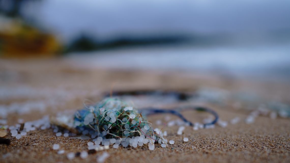 small plastic beads on an ocean beach