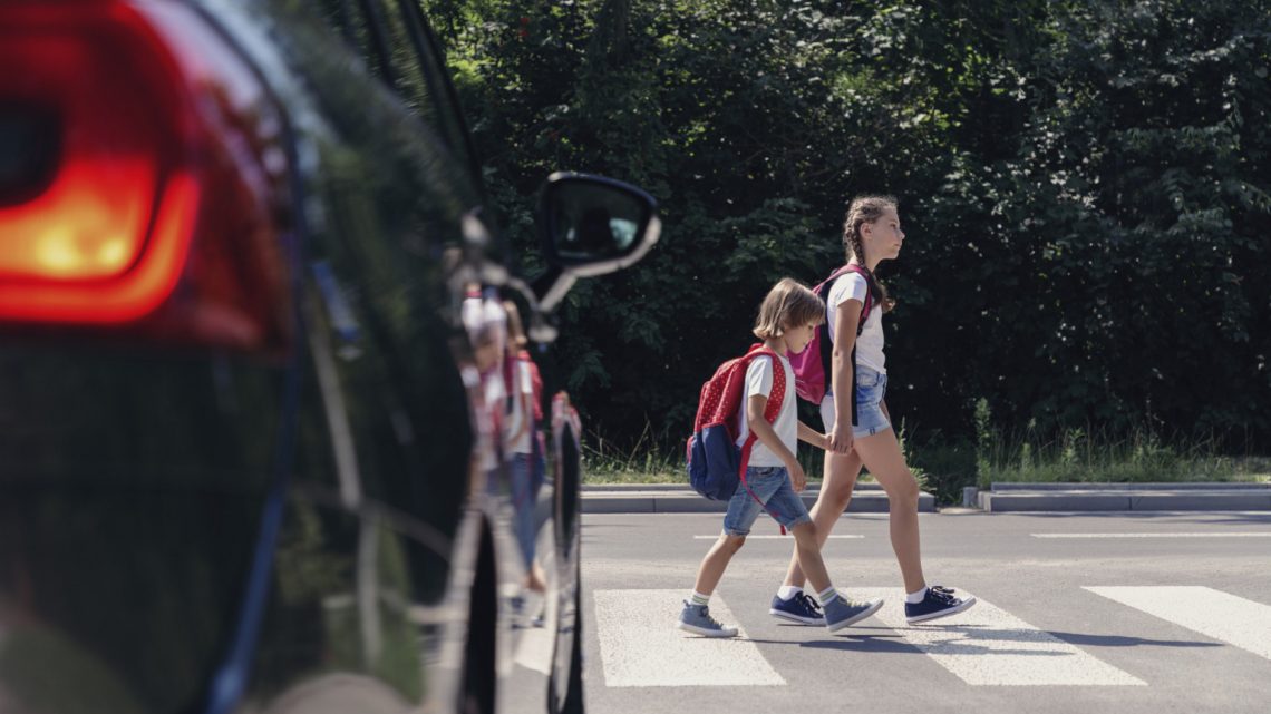 two children crossing the street