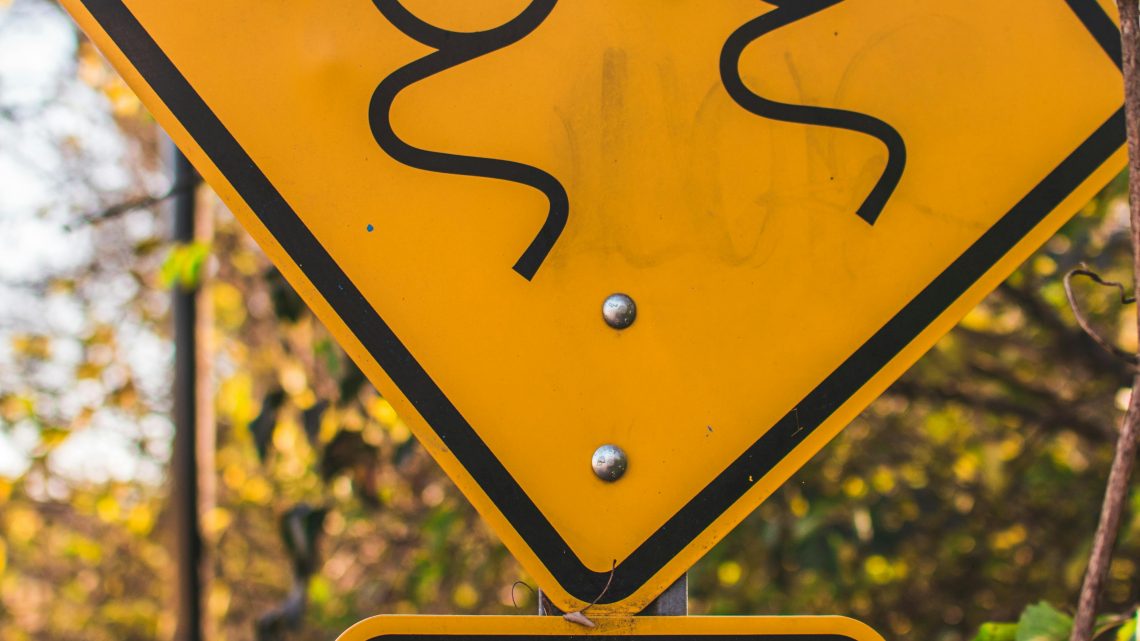 slippery road sign