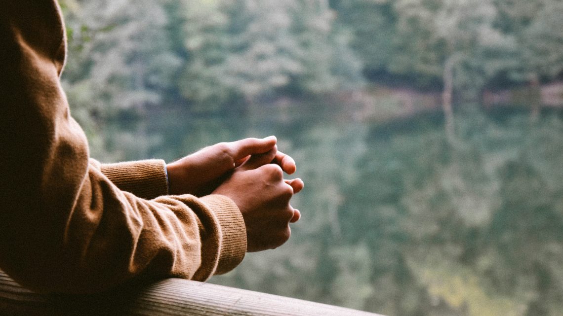 person looking out at lake