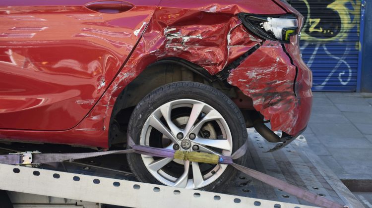 Wrecked Car Strapped Down to a Tow Truck